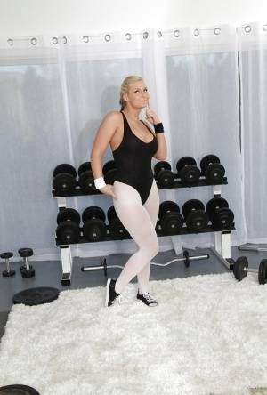 Hot blonde with flexy body Phoenix Marie slipping off her sport outfit on adultfans.net