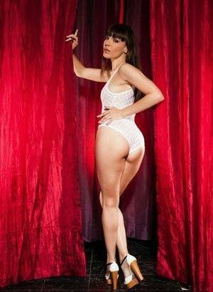 Leggy brunette Dana Dearmond sets her boobs free from bodysuit in heels on adultfans.net
