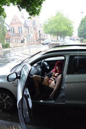Mature redhead Barby Slut gets naked in public places on a wet day on adultfans.net