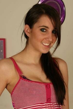 Young brunette Stacy H gets completely naked on a wooden table on adultfans.net