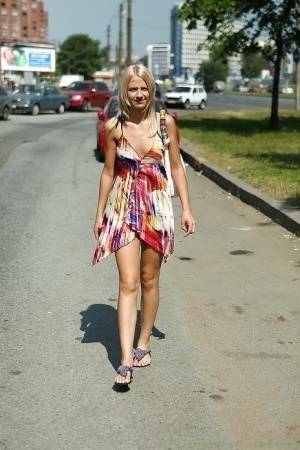 Charming teen blonde posing solo in a lovesome dress outdoor on adultfans.net