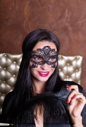 Sexy brunette Leyla Lee removes a mask and robes to pose nude with a feather on adultfans.net