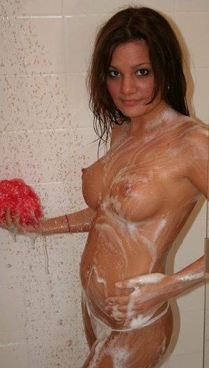 Teen amateur Kate Crush soaps her perky breasts while taking a shower on adultfans.net