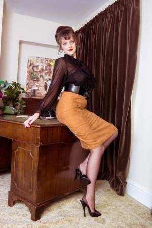 Long legged Kate Anne poses on the desk flaunting her vintage silk stockings on adultfans.net