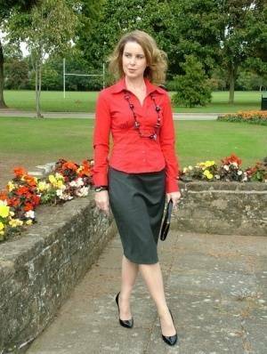 Fully clothed woman steps out of a stiletto heel while visiting a public park on adultfans.net