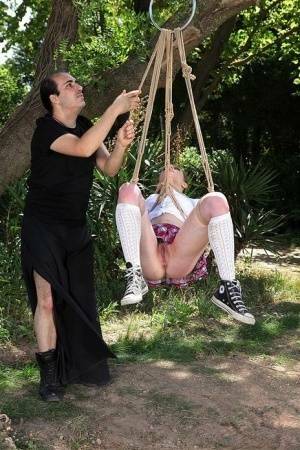 Schoolgirl Samantha Bentley finds herself suspended from ropes in the woods on adultfans.net