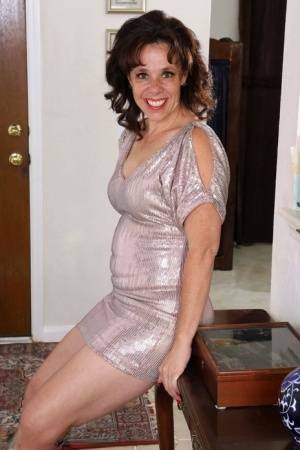 Over 30 lady Sonic takes off a short dress to pose nude on a runner on adultfans.net