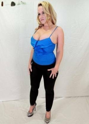 Middle-aged blonde Dee Siren displays her ample cleavage in tight pants on adultfans.net