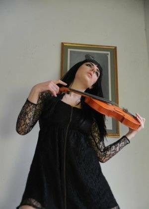 Dark haired violin player Sam Bentley strikes great poses while getting naked on adultfans.net