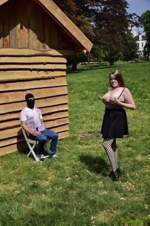 Natural redhead masturbates on a lawn before teasing a masked man on adultfans.net
