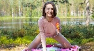 Young amateur Ava bares her hard body on a blanket near the water on adultfans.net