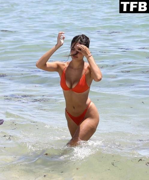 Tao Wickrath Stuns in Small Orange Bikini on the Beach in Miami on adultfans.net