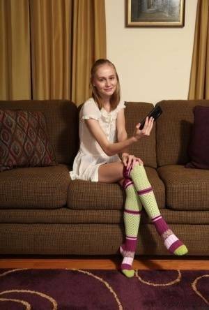 Adorable teen Alicia Williams takes a selfie before getting naked in OTK socks on adultfans.net