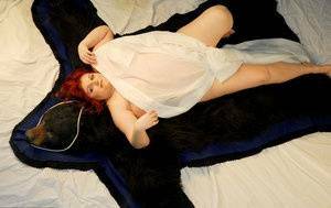 Fat redhead Black Widow AK models totally naked on a bearskin rug on adultfans.net