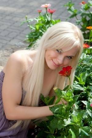 Beautiful Feeona flashes a nude upskirt and gets on her knees in the park on adultfans.net