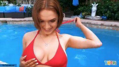 Gracie Gates coyly undoes her top in the pool on adultfans.net