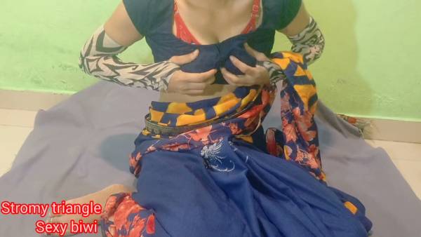 Woman with orange hair spreads her shaved vulva on a gray cloth against a green wall - India on adultfans.net