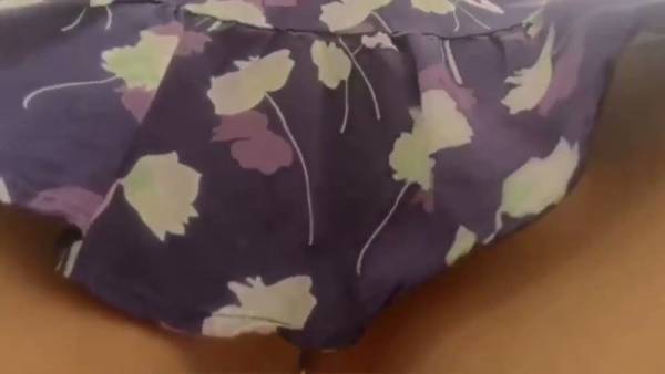 Young college girl in purple floral dress lifts her skirt to expose bare buttocks on adultfans.net