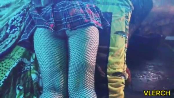 Young Latina otaku teases in fishnets and plaid under blue neon light on adultfans.net