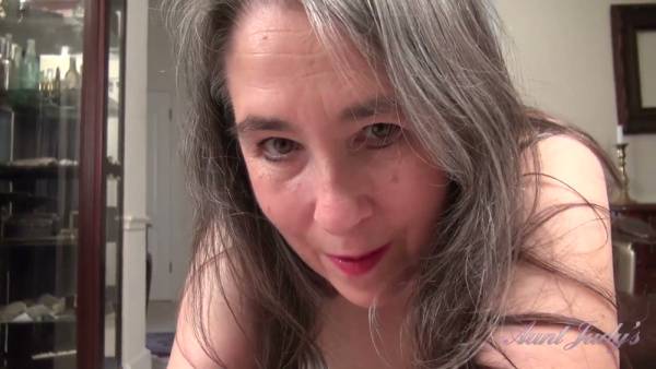 Mature gray-haired woman Grace proudly displays her natural hairy pussy in intimate solo scenes at home on adultfans.net