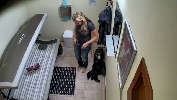 Blonde MILF prepares for a solarium session in her private hallway on adultfans.net