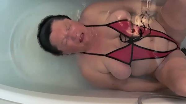 MILF in sheer swimsuit poses underwater in bathtub with legs apart on adultfans.net