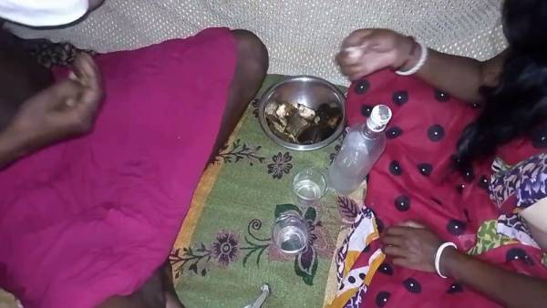 Dark-skinned woman in traditional scarf shares liquor before intimacy on floral blanket on adultfans.net