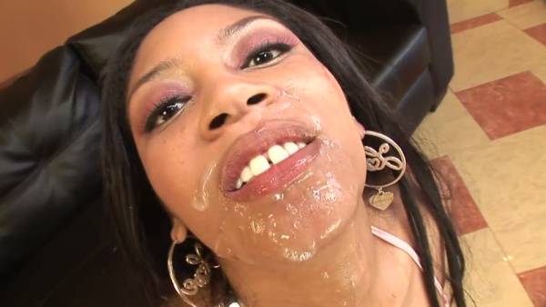 Curvy dark-skinned woman gives bareback blowjobs to multiple black men in a living room on adultfans.net