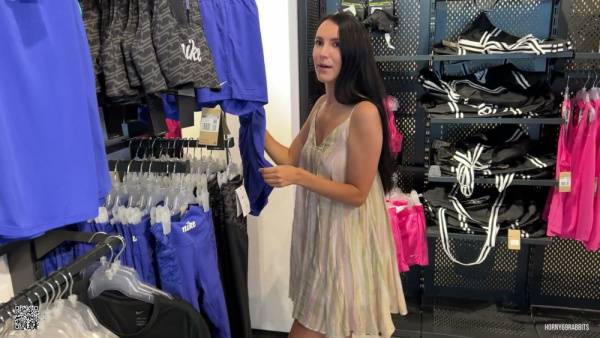Long-haired beauty teases in sheer dress as vibrator play builds to changing room tension on adultfans.net