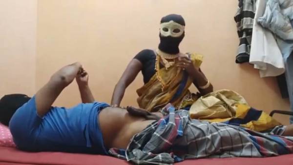Masked ebony Indian woman teases a sensual ride on her webcam from a red bed - India on adultfans.net