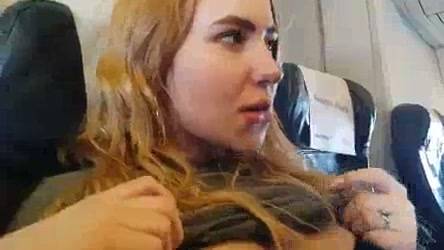 Blonde gives a discreet handjob during a flight in plain sight on adultfans.net