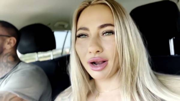 Tattooed blonde moves from car seat to grass for intense oral and handjob on adultfans.net