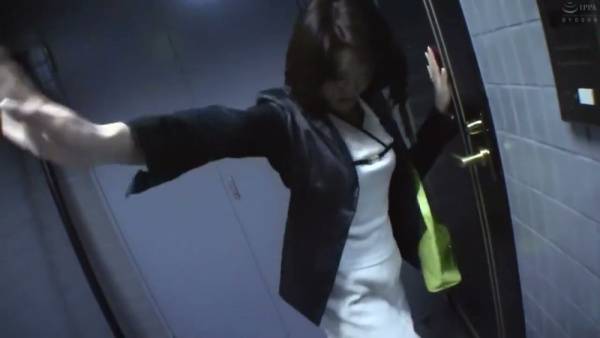 Businesswoman in blazer meets her lover in a dim office hallway before retreating to the bedroom - Japan on adultfans.net