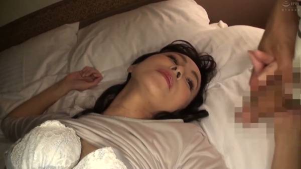 Black-haired Asian woman performs oral sex on her partner in bed - Japan on adultfans.net