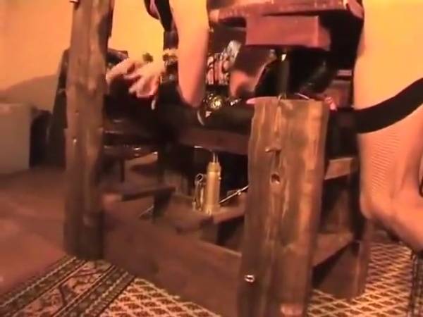 Strict latex-clad mistress disciplines her submissive with the whip in a rustic dungeon on adultfans.net