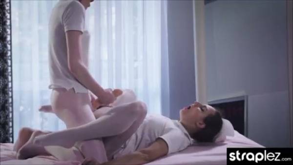 Two young men share an intimate moment as one ejaculates on the bed on adultfans.net