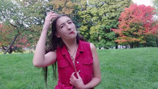 Gypsy Dolores bares it all in a red shirt while smoking in an autumn park on adultfans.net
