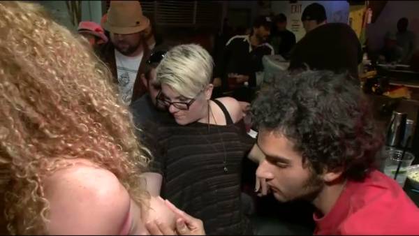 Bound blonde in yellow dress serves oral in a dimly lit fetish bar on adultfans.net