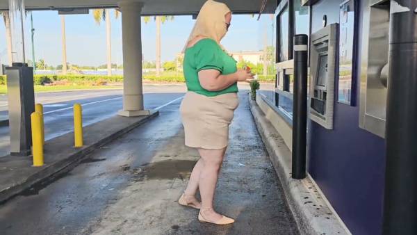 Woman in green and hijab meets stranger by silver SUV in parking lot on adultfans.net