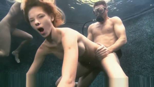 Blonde and redhead join a bearded man for an underwater threesome on adultfans.net
