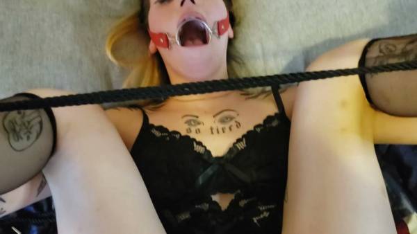 Tattooed submissive in black lace lingerie takes a deep throat with ball gag on adultfans.net
