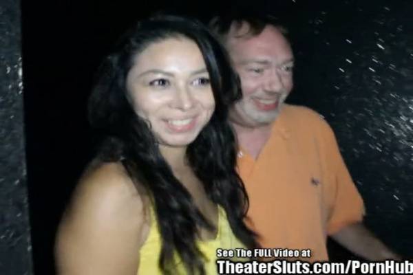 Young Asian beauty teased and shared by two men in a dimly lit lounge on adultfans.net