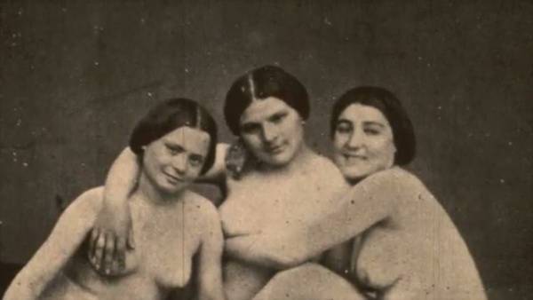 Three hairy lesbians in vintage poses share intimate moments in sepia tones on adultfans.net