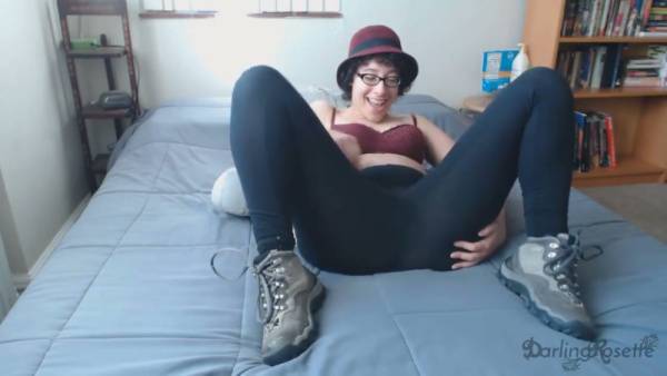 Red-haired woman in red bra and hiking boots explores herself on a bed with barred window on adultfans.net