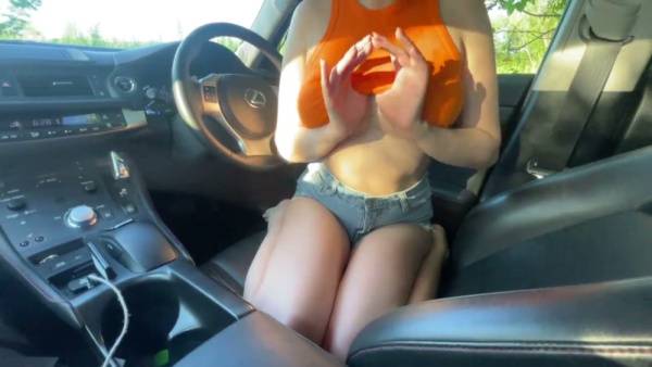 Skinny brunette with big natural tits gives head in a car after flashing her midriff on adultfans.net