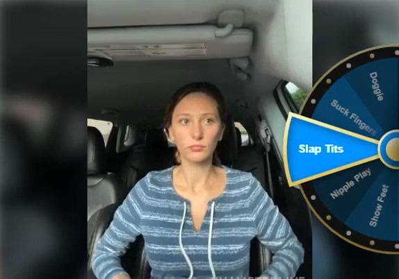 Woman spreads herself open in the front seat of a car on adultfans.net