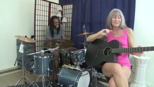 Blonde woman with gray hair takes black musician deep in throat and bed on adultfans.net