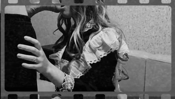 French maid in black and white poses on a sofa with book - France on adultfans.net