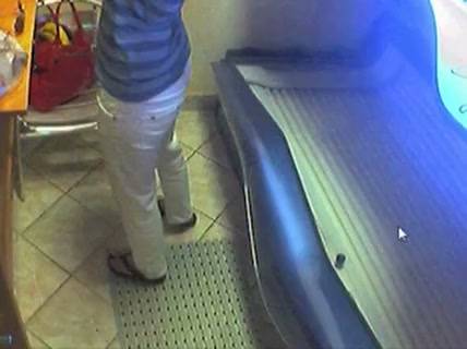 Lone figure caught on hidden cam inside glowing solarium on adultfans.net