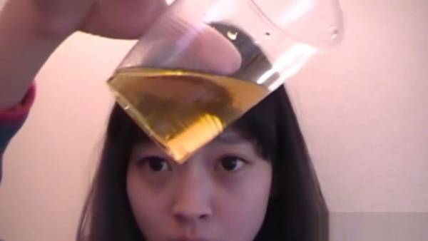 Young Asian performer sips golden fluid in intimate bathroom session on adultfans.net